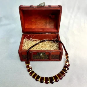 Beautiful amber necklace in vintage wooden box, showcasing intricate design and elegant craftsmanship.