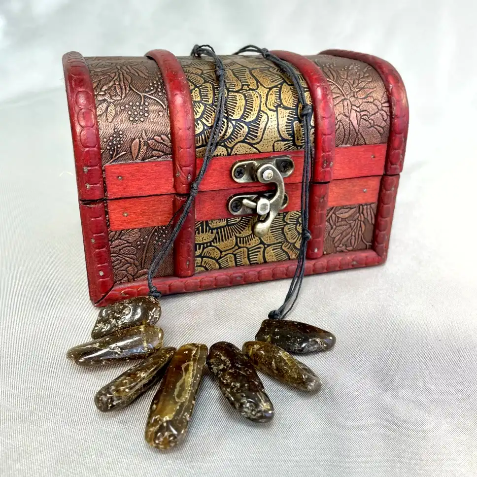 Decorative treasure chest featuring a necklace, perfect for showcasing treasured jewelry and unique artifacts.