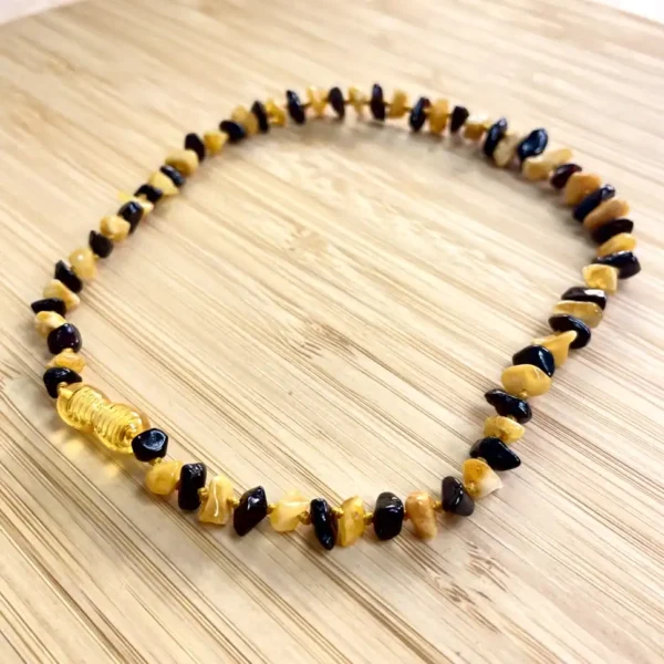Elegant amber and dark bead necklace, showcasing artisan craftsmanship and earthy tones.