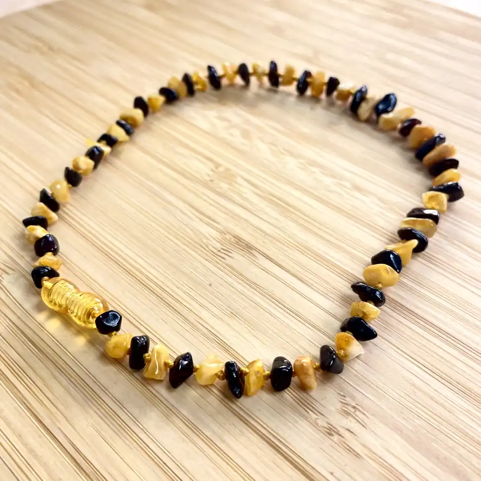 Elegant amber and dark bead necklace, showcasing artisan craftsmanship and earthy tones.