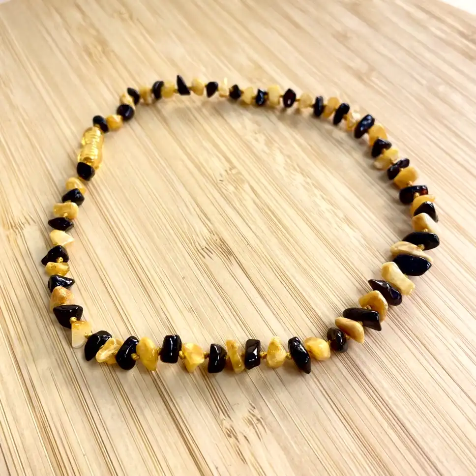 Artisan amber and onyx necklace, featuring a unique blend of natural stones and rich colors.